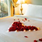 Romantic rose petals on bed