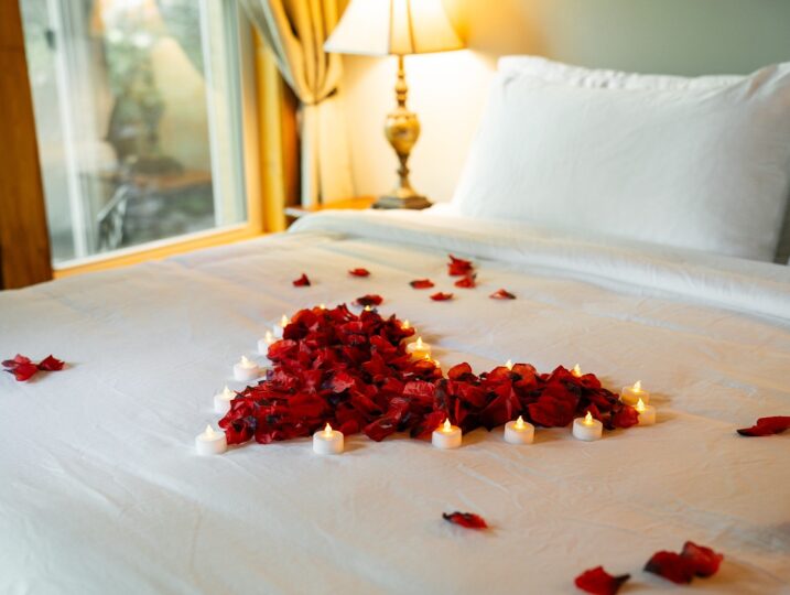 Romantic rose petals on bed